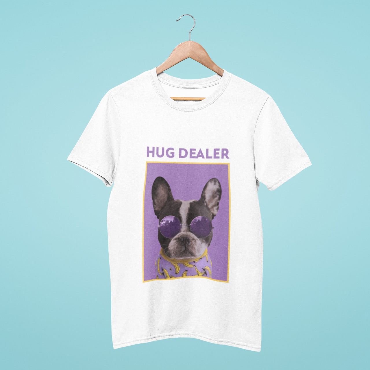 This white t-shirt features a French bulldog sporting trendy purple round sunglasses, with the title "hug dealer" written in bold letters. Spread positive vibes and embrace your inner hug dealer with this fun and playful tee. Perfect for dog lovers and those who love spreading love and kindness.