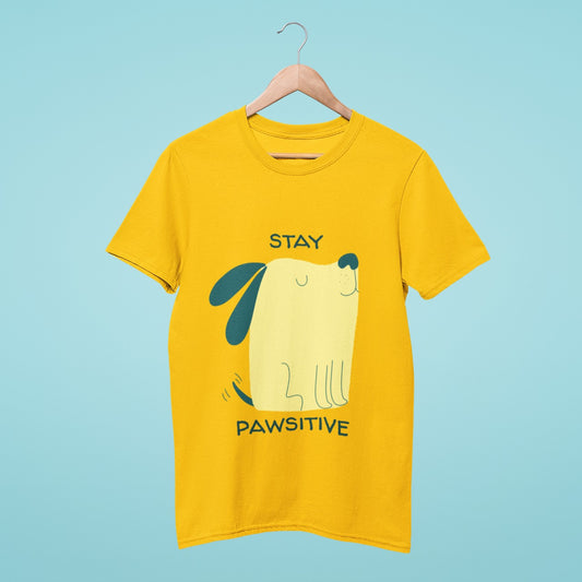 This yellow t-shirt features an adorable cartoon dog sitting and wagging its tail, with the title "Stay Pawsitive." Spread positivity and show off your love for dogs with this cute and comfortable tee. Perfect for any casual occasion, this shirt is a must-have for any dog lover's wardrobe. Stay pawsitive and let your style shine with this cheerful shirt.