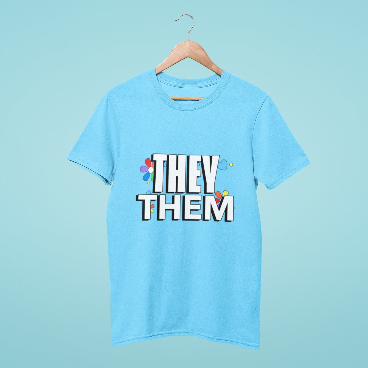 Our sky blue round neck t-shirt features a 'They Them' design with beautiful rainbow flowers in the background, making it a perfect addition to your wardrobe. Show your support for gender-neutral pronouns while staying stylish and comfortable. Made with high-quality materials and available in various sizes, order now to spread positivity and inclusivity.