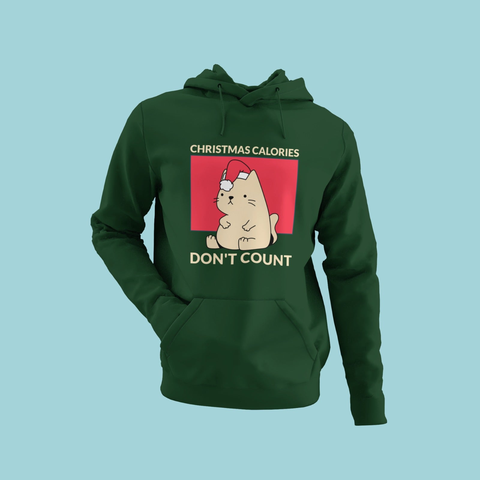 Get into the holiday spirit with this olive green hoodie featuring a chubby cat wearing a Christmas cap holding its filled tummy with a "Christmas calories don't count" message. Stay cozy and stylish all season long with this comfortable and festive hoodie. Order now to add some holiday cheer to your wardrobe!